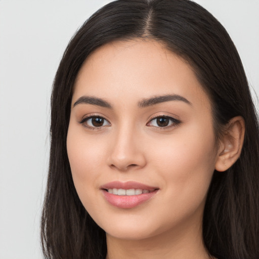 Joyful asian young-adult female with long  brown hair and brown eyes