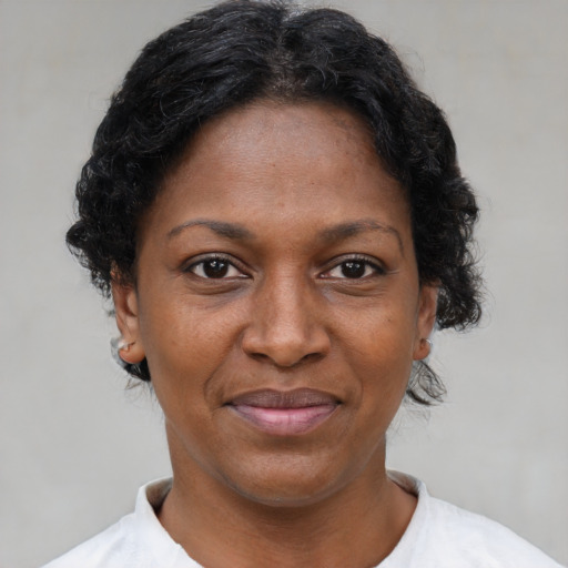 Joyful latino adult female with short  brown hair and brown eyes