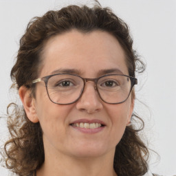 Joyful white adult female with medium  brown hair and grey eyes