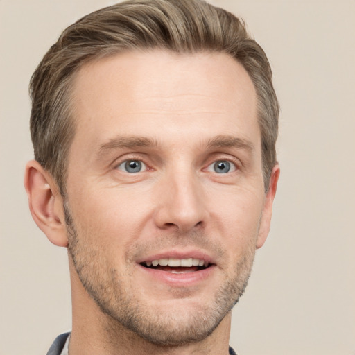 Joyful white adult male with short  brown hair and grey eyes