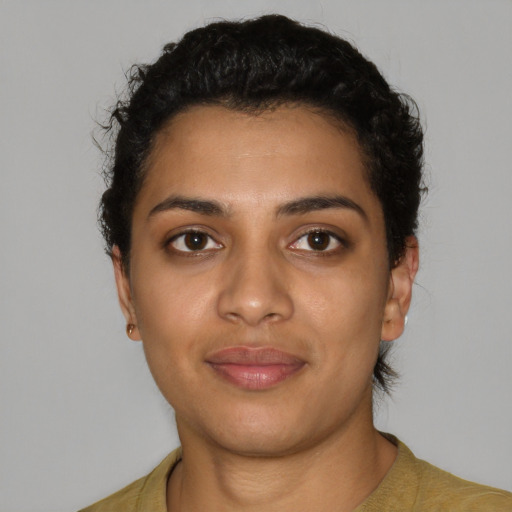 Joyful latino young-adult female with short  black hair and brown eyes