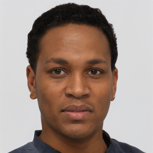 Joyful black young-adult male with short  black hair and brown eyes