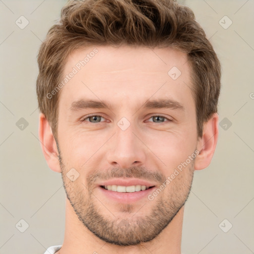 Joyful white young-adult male with short  brown hair and grey eyes