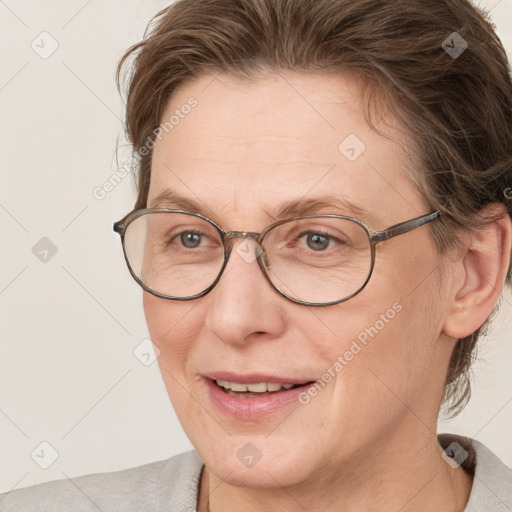 Joyful white adult female with short  brown hair and brown eyes