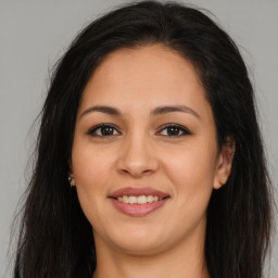 Joyful asian young-adult female with long  brown hair and brown eyes