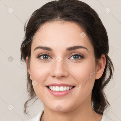 Joyful white young-adult female with medium  brown hair and green eyes