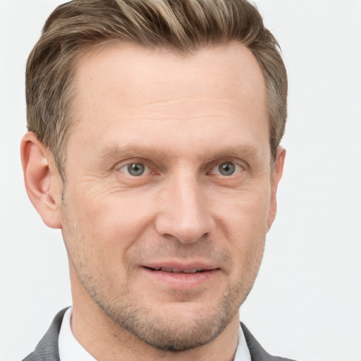 Joyful white adult male with short  brown hair and grey eyes