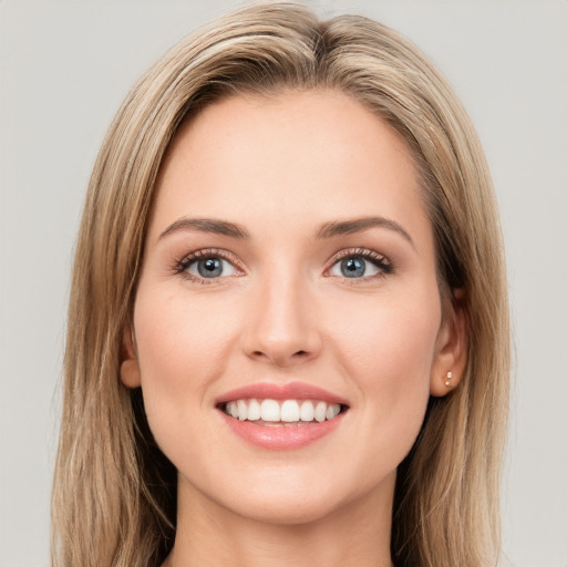 Joyful white young-adult female with long  brown hair and green eyes