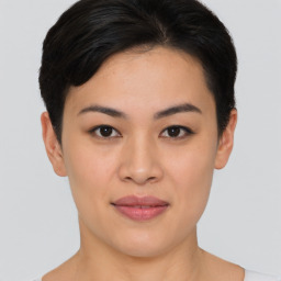 Joyful asian young-adult female with short  brown hair and brown eyes