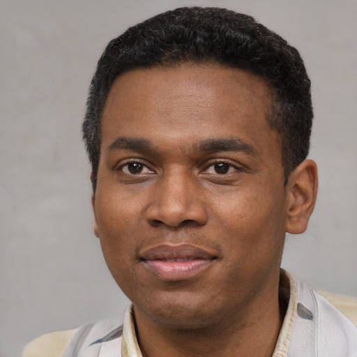 Joyful latino young-adult male with short  black hair and brown eyes