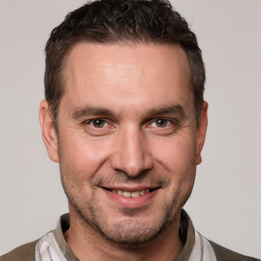 Joyful white adult male with short  brown hair and brown eyes