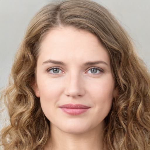 Joyful white young-adult female with long  brown hair and green eyes