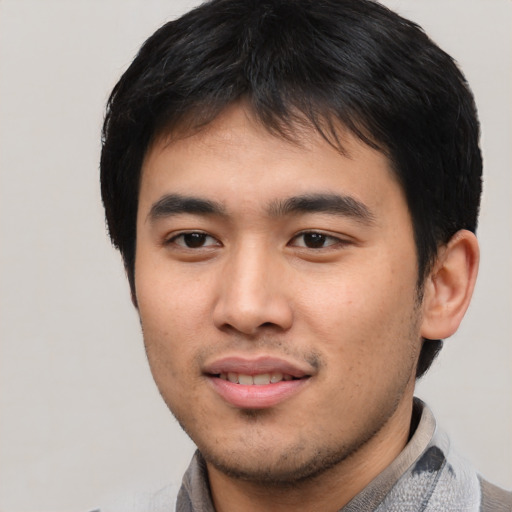 Joyful asian young-adult male with short  black hair and brown eyes