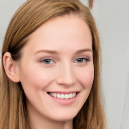 Joyful white young-adult female with long  brown hair and blue eyes