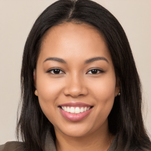 Joyful latino young-adult female with long  black hair and brown eyes