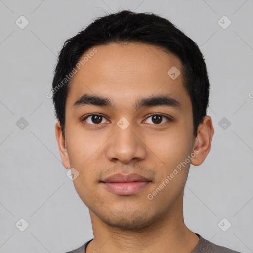 Joyful latino young-adult male with short  black hair and brown eyes