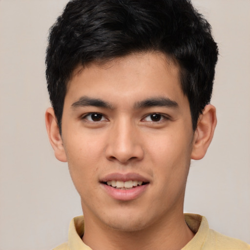Joyful asian young-adult male with short  black hair and brown eyes