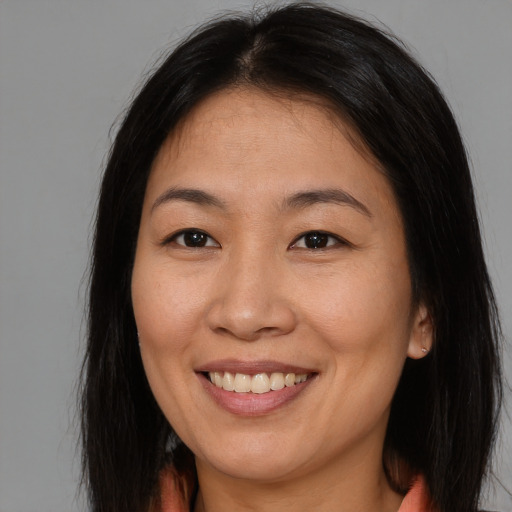 Joyful asian young-adult female with medium  brown hair and brown eyes