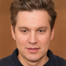 Joyful white adult male with short  brown hair and brown eyes