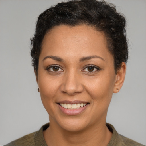 Joyful latino young-adult female with short  brown hair and brown eyes