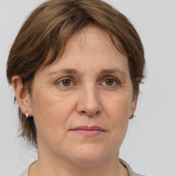 Joyful white adult female with medium  brown hair and grey eyes