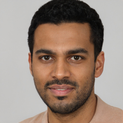 Joyful latino young-adult male with short  black hair and brown eyes
