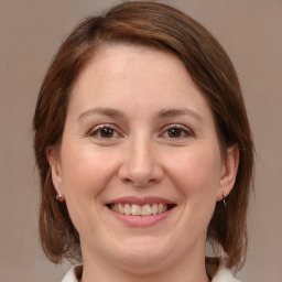 Joyful white adult female with medium  brown hair and brown eyes