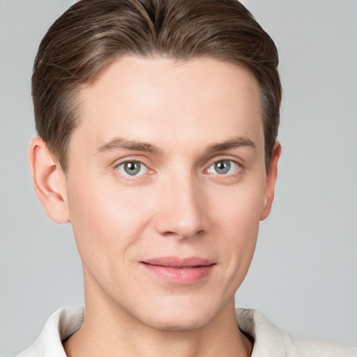 Joyful white young-adult male with short  brown hair and grey eyes