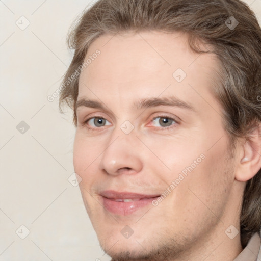 Joyful white young-adult male with medium  brown hair and brown eyes