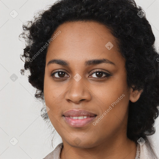 Joyful black young-adult female with long  black hair and brown eyes