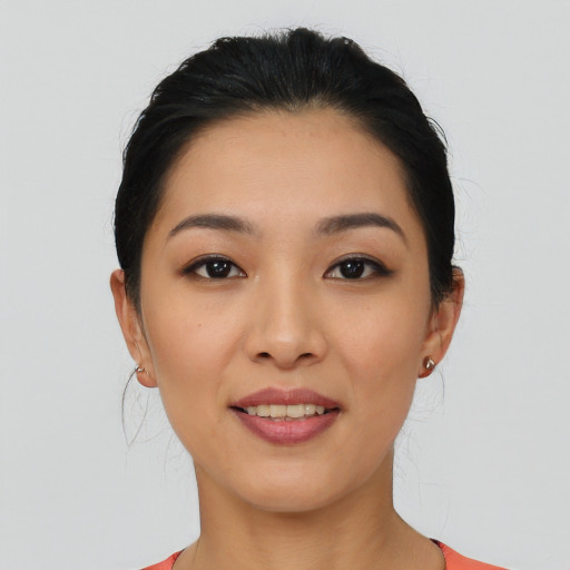 Joyful asian young-adult female with medium  black hair and brown eyes