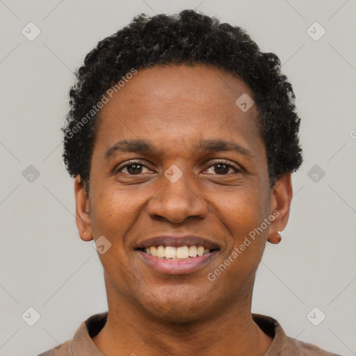 Joyful black adult male with short  black hair and brown eyes