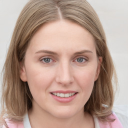 Joyful white young-adult female with medium  brown hair and blue eyes