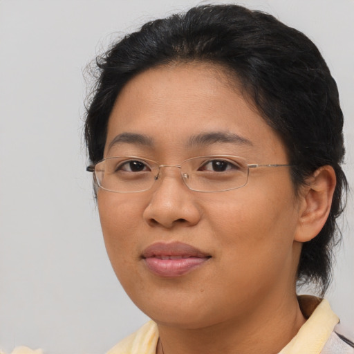 Joyful asian adult female with short  brown hair and brown eyes