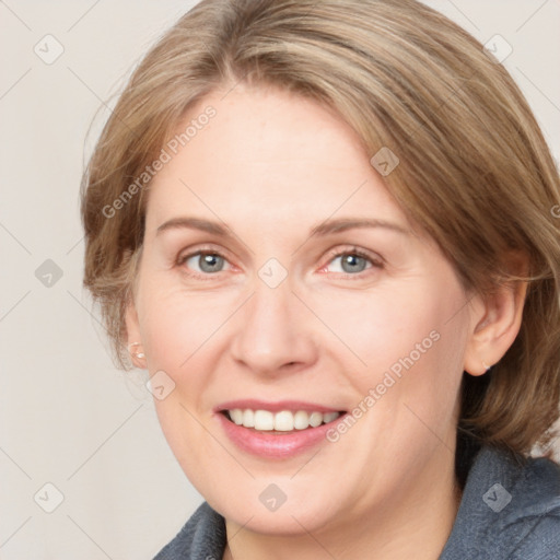 Joyful white adult female with medium  brown hair and blue eyes