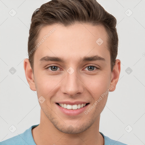 Joyful white young-adult male with short  brown hair and grey eyes