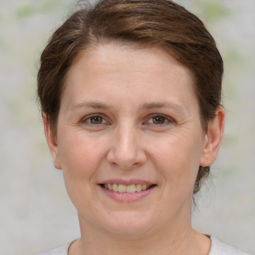 Joyful white adult female with short  brown hair and brown eyes