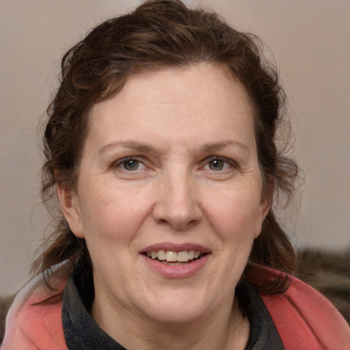 Joyful white adult female with medium  brown hair and grey eyes