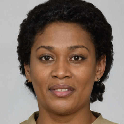 Joyful black adult female with short  brown hair and brown eyes