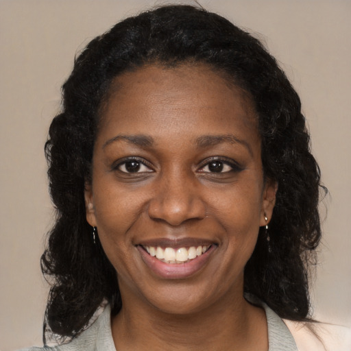 Joyful black adult female with medium  black hair and brown eyes