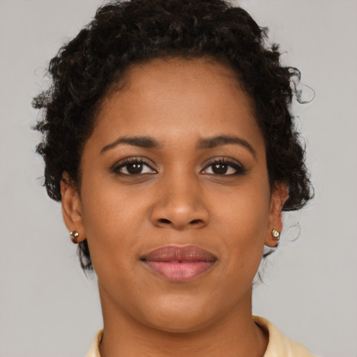 Joyful black young-adult female with short  brown hair and brown eyes