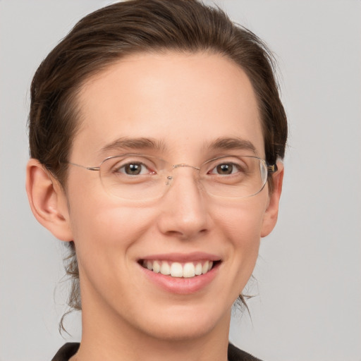 Joyful white young-adult female with medium  brown hair and grey eyes