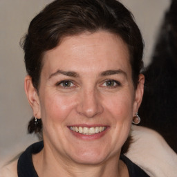 Joyful white adult female with medium  brown hair and grey eyes