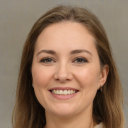 Joyful white young-adult female with long  brown hair and grey eyes