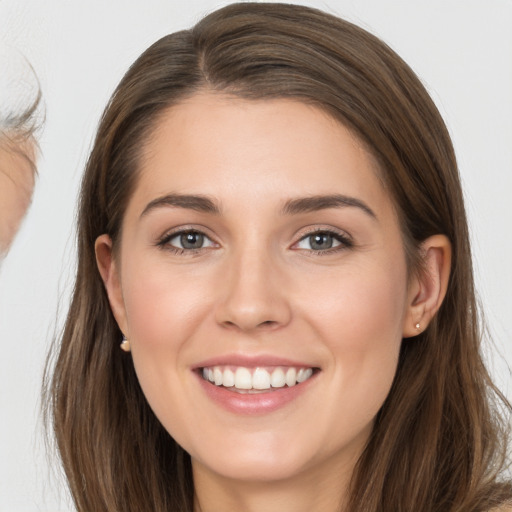 Joyful white young-adult female with long  brown hair and brown eyes