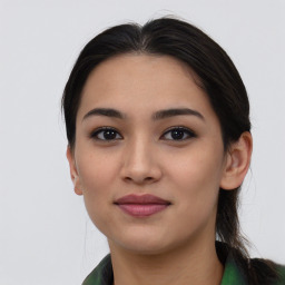 Joyful asian young-adult female with long  brown hair and brown eyes