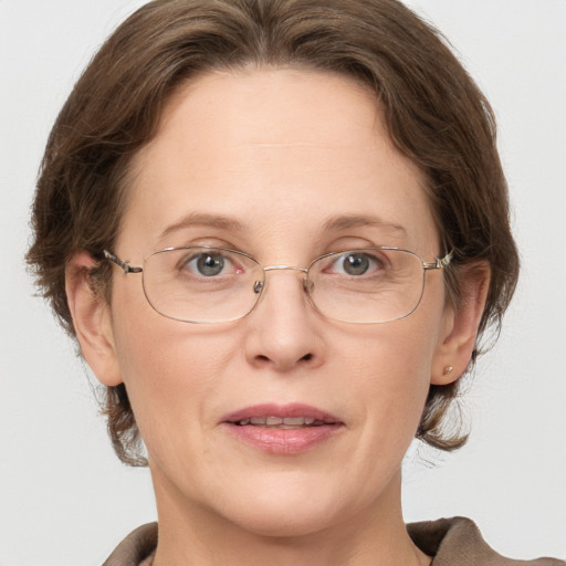 Joyful white adult female with medium  brown hair and grey eyes