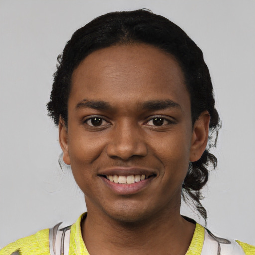 Joyful black young-adult male with short  black hair and brown eyes