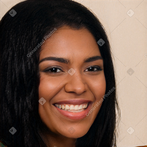 Joyful black young-adult female with long  brown hair and brown eyes