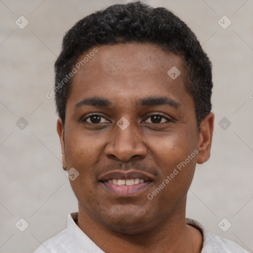 Joyful black young-adult male with short  black hair and brown eyes